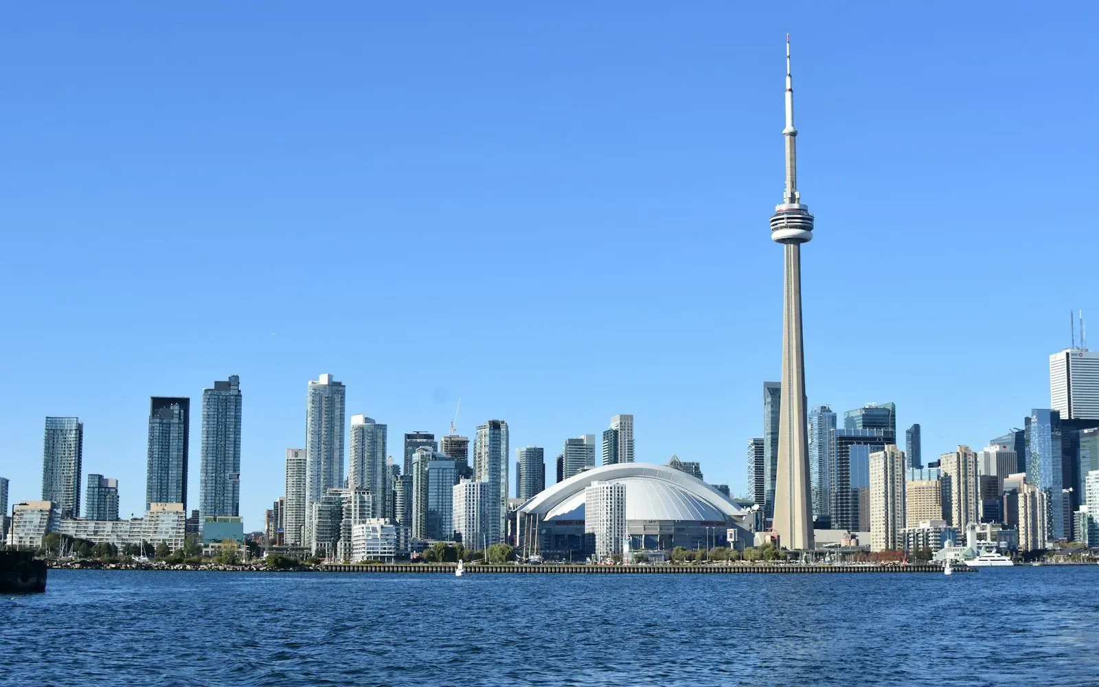Toronto skyline and CN Tower seen from Lake Ontario under a clear blue sky